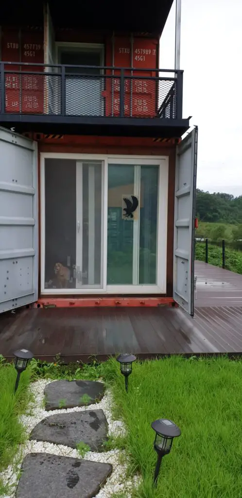 Orange Shipping Container House In Green Nature